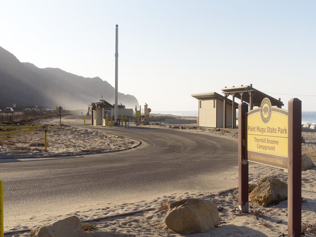 Entrance to Thornhill Broome Campground at Point Mugu State Park, featuring signage and sandy terrain.