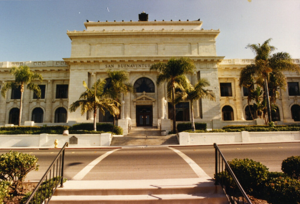 Frontal view of Ventura City Hall featuring neo-classical architecture with grand steps and palm trees, circa 1980s.