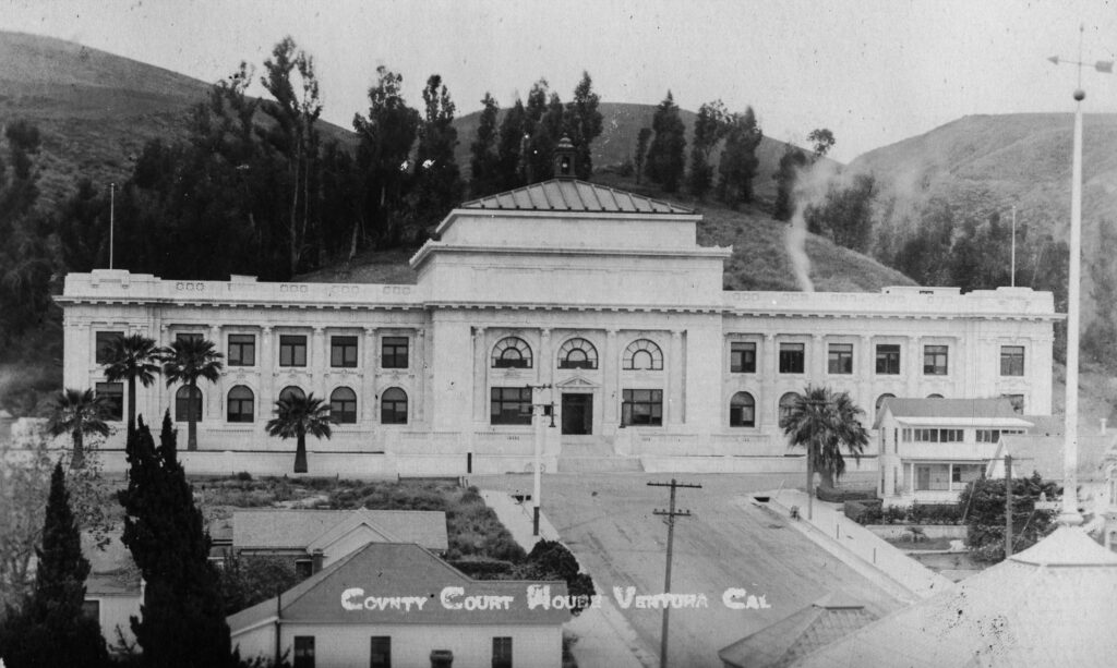 Black and white historical photograph of the former Ventura County Courthouse, showcasing its architecture and surroundings.